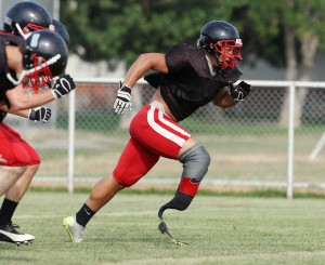 Koni Dole practices with the Huntley Project football team last week in Worden.